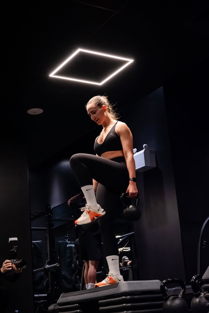 The coach is posing at the gym.